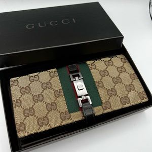 Gucci GG wallet with buckle.